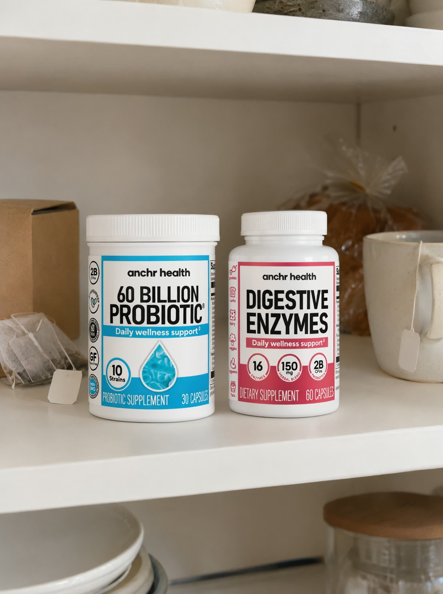 The Anchr 60 Billion Probiotic and Digestive Enzymes bottles on a kitchen shelf next to tea, a mug and bread.