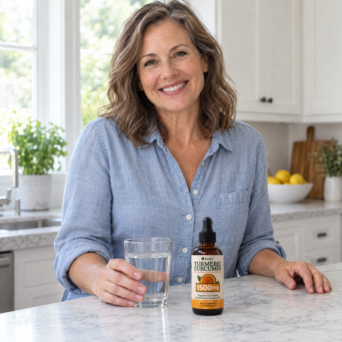A smiling woman in her kitchen with a glass of water and the Anchr bottle