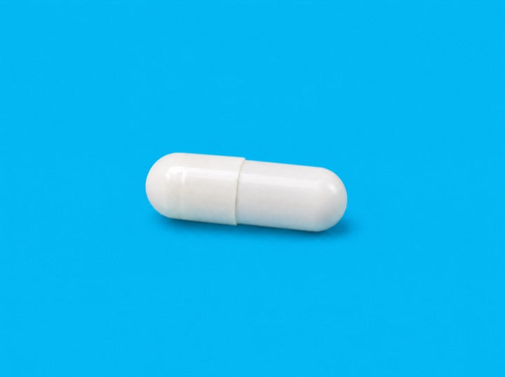 A white probiotic capsule